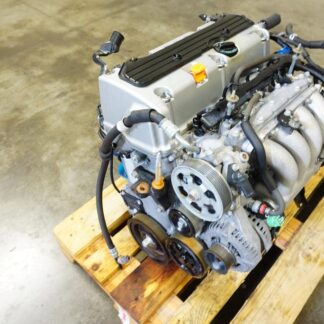 Honda K24 engine for sale USA on wooden pallet Honda K24A2 2.4L DOHC i-VTEC engine JDM K24 engine in engine warehouse K24 engine inspection and testing K24 engine secured on shipping pallet